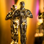 a number of oscar statues on a table